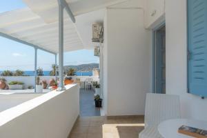 a white house with a view of the ocean at Angeliki Pension in Katapola
