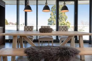 a dining room with a table and chairs and windows at Radisson Blu Hotel, St. Gallen in St. Gallen
