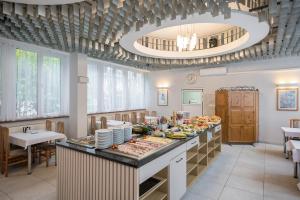 a large kitchen with a buffet with food on it at Hotel *** NAT Krynica Zdrój in Krynica Zdrój