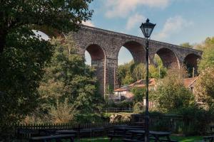 a stone bridge with benches and a street light at The Rising Sun - Pensford in Pensford