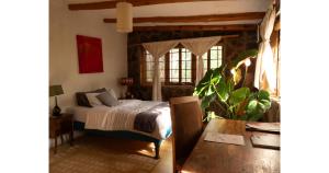 a bedroom with a bed and a table in a room at Oloile - Home By The Park in Nairobi