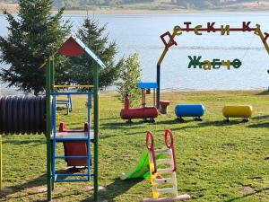 a playground with different types of play equipment in a field at Ваканционно селище Ива in Sarnitsa