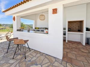 a kitchen with a table and chairs on a patio at Hacienda Gallego in Málaga