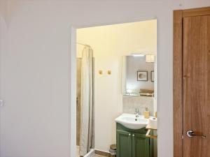 a bathroom with a sink and a mirror at Hacienda Gallego in Málaga