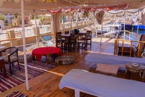 a restaurant on a boat with tables and chairs at 1Water Lily in Luxor