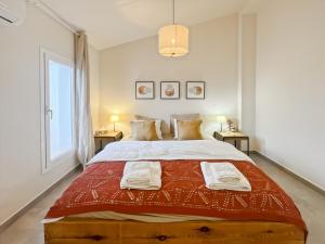 a bedroom with a large bed with two tables at Hacienda Gallego in Málaga