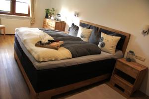 a bedroom with a large bed with a tray on it at Ferienhaus Hartmut Löschke in Rheinsberg