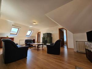 a living room with two chairs and a table at Csenár Apartman Hegykő in Hegykő