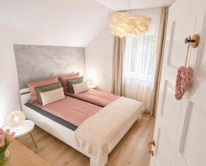 a bedroom with a large bed and a chandelier at Zen Retreat House Sovata in Sovata +11 photos