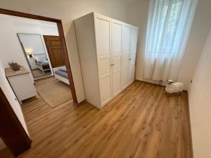 a room with white cabinets and a hard wood floor at Ferienhaus Anna in Winsen +23 photos