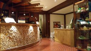 a bar in a restaurant with a pile of wood at Landhotel Binderhäusl Garni in Inzell