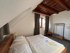 a bedroom with a large white bed in a room at Koczor Winery & Guesthouse in Balatonfüred
