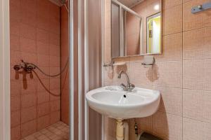 a bathroom with a sink and a mirror and a shower at Velga in Vilnius +53 photos
