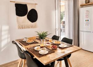 a dining room table with breakfast food on it at Hauzify I Casa Olivella B in Olivella