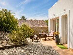 a patio with a table and chairs in a yard at Hauzify I Casa Olivella B in Olivella
