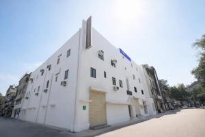 a large white building on a city street at FabHotel The Fortune in New Delhi