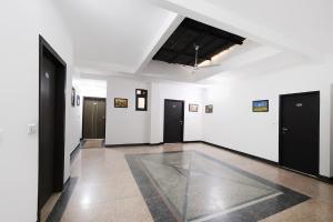 a hallway with black doors and white walls at FabHotel The Fortune in New Delhi +28 photos