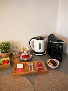 a kitchen counter with a coffee maker and a tray of food at Neverland Deluxe in Santa Maria