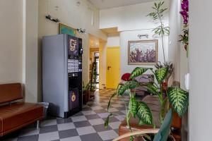 a lobby with a vending machine and plants at Velga in Vilnius
