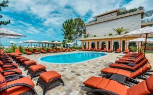 a pool with chairs and umbrellas at a resort at Dreamland Aparts in Chakvi