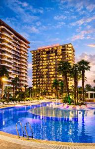 a large swimming pool in front of a hotel at Dreamland Aparts in Chakvi