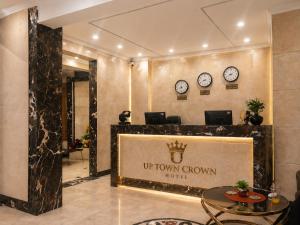 a hotel lobby with a sign that reads up town crown hotel at Up Town Crown Hotel in Cairo
