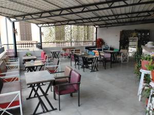 an empty patio with tables and chairs and tablesearcher at Up Town Crown Hotel in Cairo
