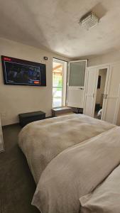 a bedroom with a bed and a tv on the wall at Villa Dependance in Taranto