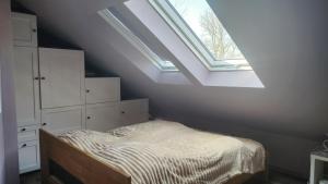 a bedroom with a bed and a skylight at Sorayas Welt in Neufeld