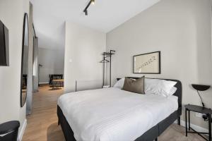 a bedroom with a large bed with white sheets at Sanctuary Hotel - En Suite Rooms in Aberdeen