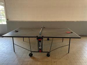 a ping pong table with a ping paddle on it at L Atelier in Angoulême