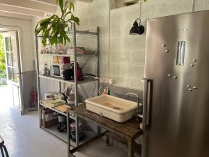 a kitchen with a sink and a refrigerator at L Atelier in Angoulême