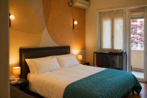 a bedroom with a bed and a desk and a window at Vatican Dolce Remy Guest House - Metro Cipro in Rome