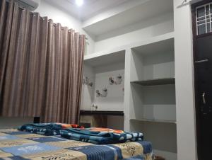 two beds in a room with curtains at DEV PALACE Hotel & Hostel in Palāi