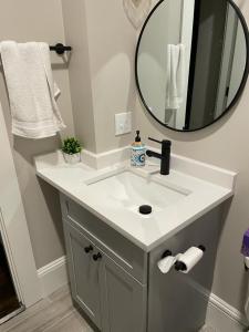 a bathroom with a white sink and a mirror at Homestay in Boston Fields Corner Area in Boston