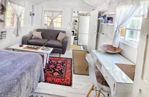 a room with a bed and a couch and a table at Oh so Heavenly in Cape Town