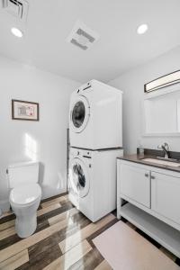 a bathroom with a washing machine and a toilet at Boston First floor condo in Framingham