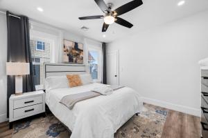 a bedroom with a bed and a ceiling fan at Boston First floor condo in Framingham