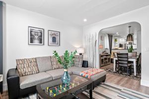 a living room with a couch and a table at Boston First floor condo in Framingham +27 photos