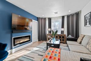 a living room with a couch and a fireplace at Boston First floor condo in Framingham