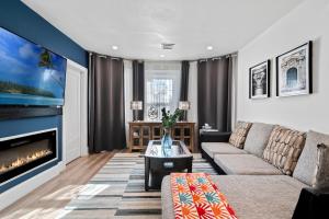 a living room with a couch and a fireplace at Boston First floor condo in Framingham