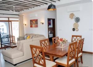 a living room with a table and a couch at WakaWaka SeaView Beach Condo in Mombasa