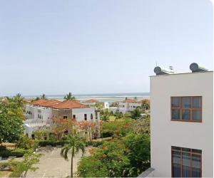 a white building with a view of a city at WakaWaka SeaView Beach Condo in Mombasa