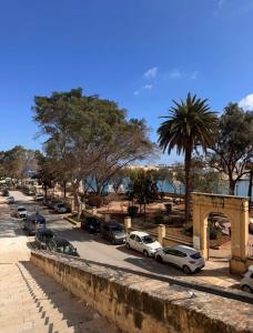 a street with cars parked in a parking lot at Valletta Waterfront Hideaway in Il-Furjana +2 photos