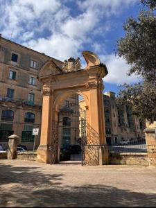 a building with an arch in front of a building at Valletta Waterfront Hideaway in Il-Furjana