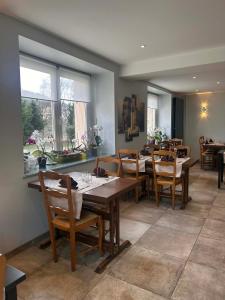 a dining room with wooden tables and chairs at Logis Hôtel Restaurant Les Cévennes in Saint-Cirgues-en-Montagne