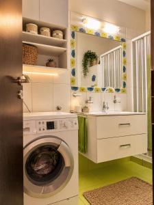 a laundry room with a washing machine and a sink at Vitamin Sea Luxury Villas in Agia Pelagia +119 photos