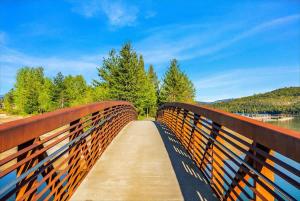 a bridge over a body of water with trees at Comfy & close to Lake Pend Oreille & Schweitzer in Dover