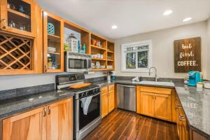 a kitchen with wooden cabinets and a stove top oven at Lakefront retreat with view deck & private dock in Shelton