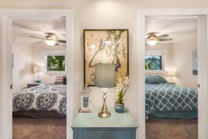 a bedroom with two beds and a table with a lamp at Lakefront retreat with view deck & private dock in Shelton